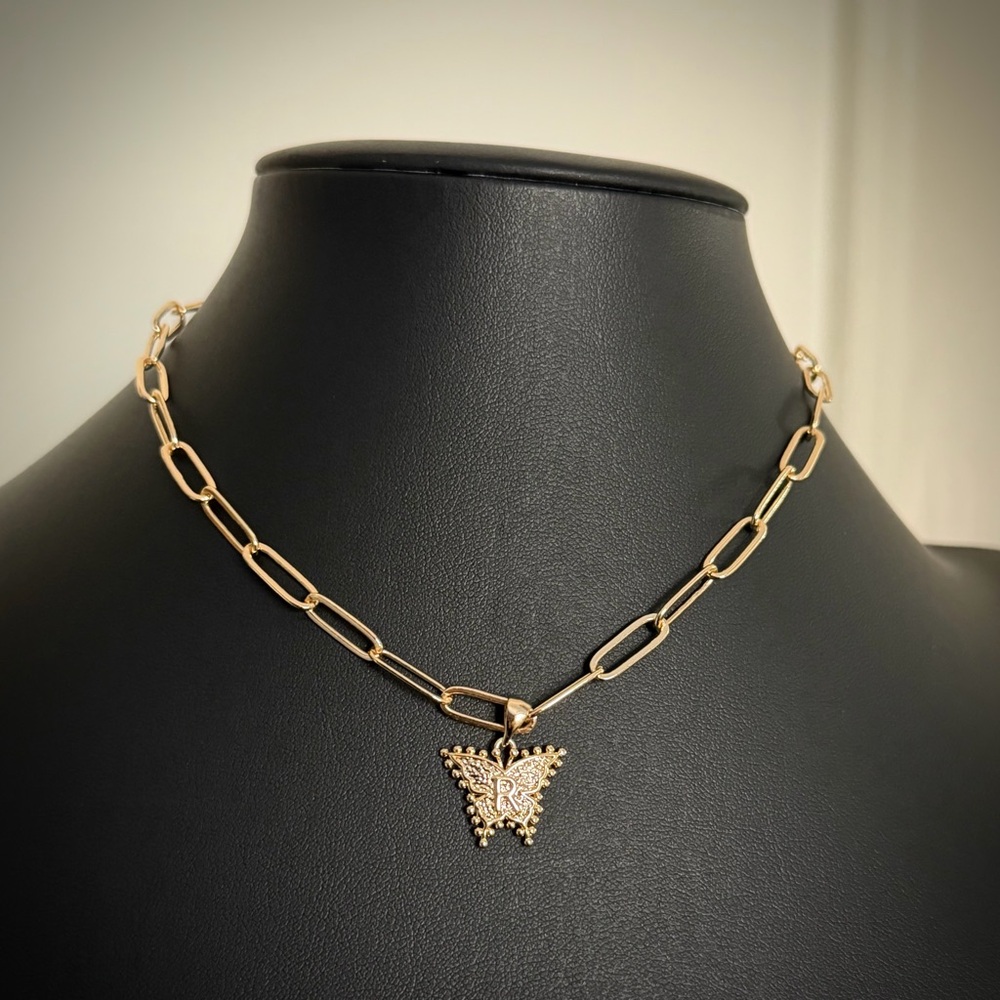 Gold toned paper clip choker with butterfly R charm